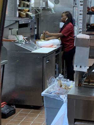 no glove, no mask. she did put gloves on later to make sandwiches but then used those gloved hands to move her hair back.