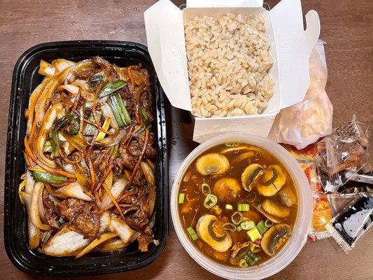 Mongolian beef on left, small hot and sour soup and brown rice on right