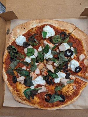 Diablo sauce, ricotta cheese, chicken, black olives, baby spinach, and fresh basil leaves.