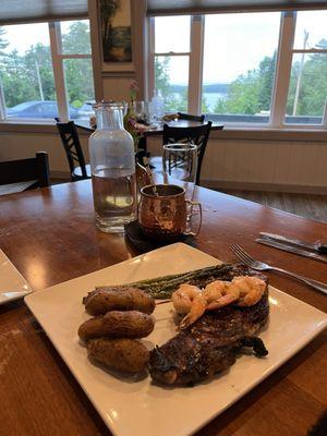 Steak, fingerling potatoes, shrimp skewer, and Parmesan crusted asparagus