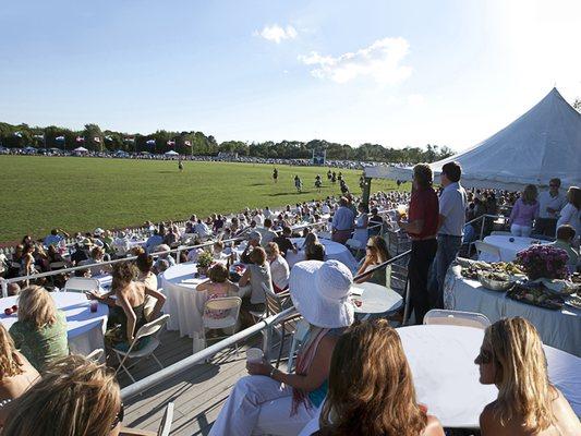 Spectators watch the action from the centerfield Pavilion during the Newport International Polo Series.