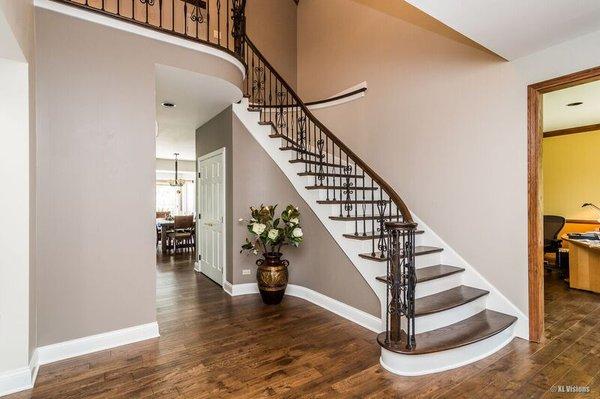 Using 2 different colors on the walls along with painting the stringers and risers created an elegant entryway.