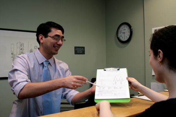 Our friendly front desk staff helping with paperwork.