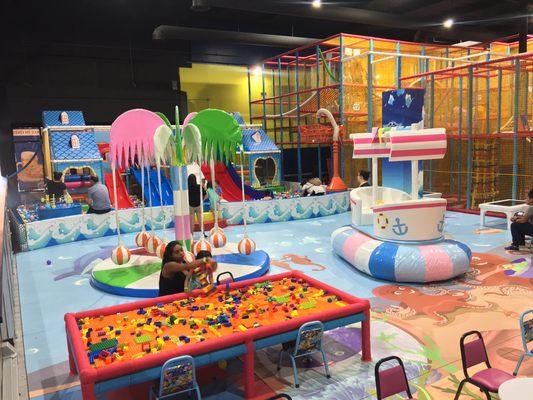 Toddler Area with ball pit, sensory stimulating games, slides, kids videos and work tables!