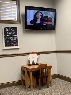 Kids table in waiting area (cute basketball tooth decor) and TV