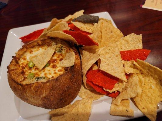 Spinach artichoke dip in toasted sour dough bread bowl