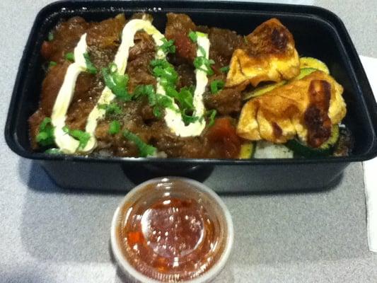 Stewed beef bento box with dumplings.