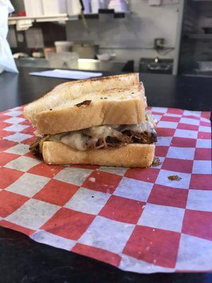 Bob's Reuben-pulled-pork w/ sweet sauce (or can choose) sautéed onions, Swiss cheese, coleslaw and spicy stone-ground mustard mayo.