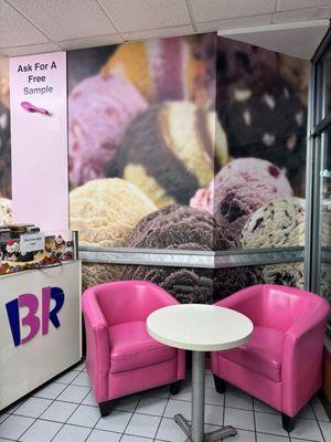 Cool Seating area with bright pink chairs to the right of the entrance