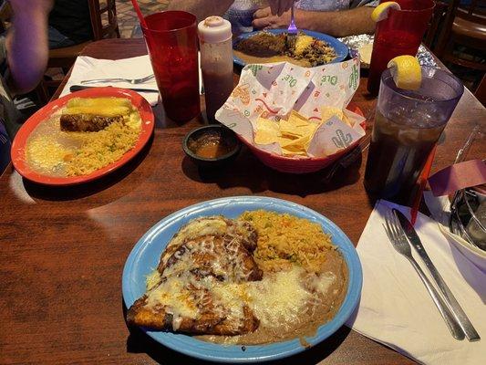 Chihua 's Enchiladas (closest plate), Enchiladas Bandera (plate on left), some type of chopped Beef situation (opposite side of table).