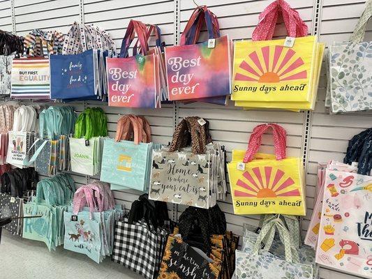 Lots of fun shopping bags available for purchase at the checkout area.