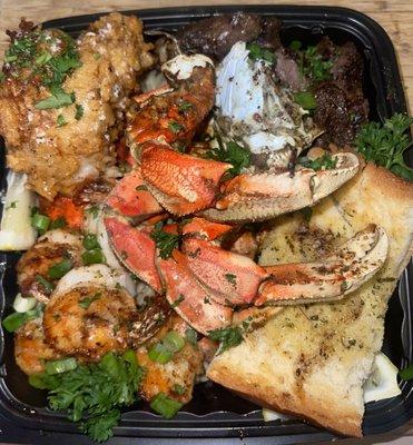 Full Buss Down Plater: Dungeness Crab, Prawns, Rib Eye Steak, Fried Lobster Tail, Over Garlic Noodles