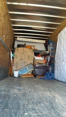 Another view of the loaded truck as we work our way back and goods are emptied...  This couples precious belongings were treated like trash.