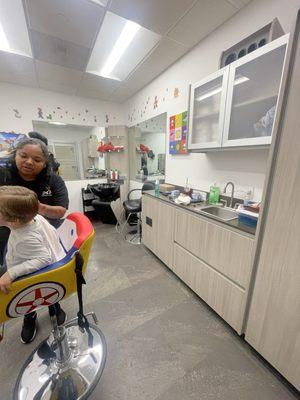 Galley type space. Kids chair with steering wheel and a police car chair.