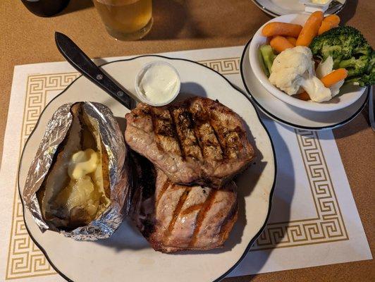 Pork chops with baked potato and vegetable