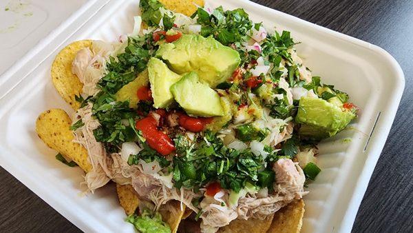 Poznachos with chicken and all toppings, including double avocado.