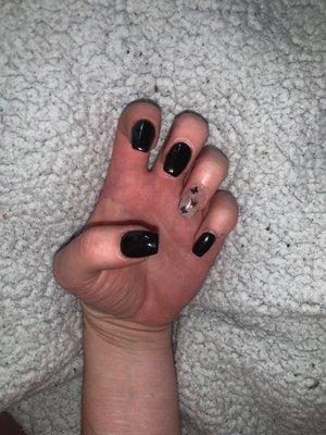 Gel full set, coffin shaped- with a star accent nail and the rest black.