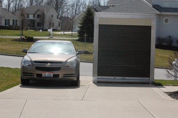 Same car from front view passing by Bins container