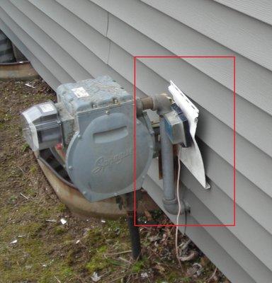 meter left unattached with old siding on it