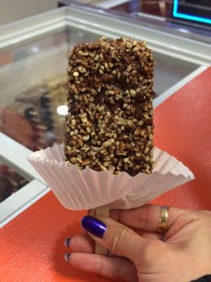 We ordered a pistachio ice cream Popsicle. We asked to get it dipped in chocolate and pecans.