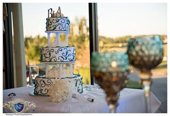 gorgeous wedding cake with teal and white scrolls at Eagle Creek Golf Club