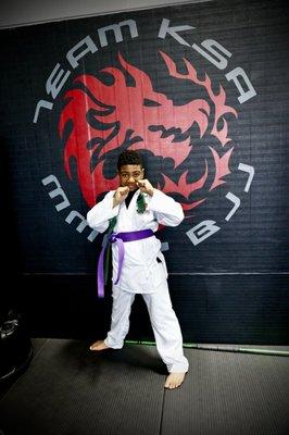 Student now wearing new  purple belt.