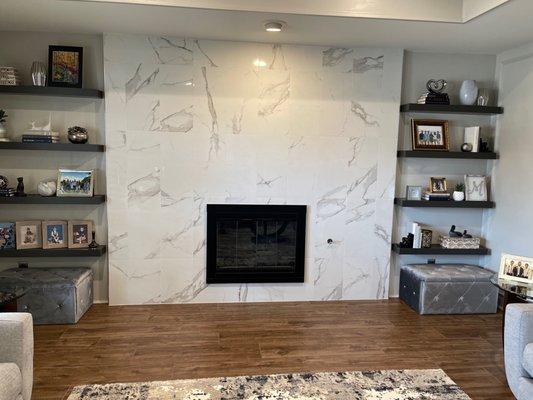 New fireplace, tile floor, and wood shelves.