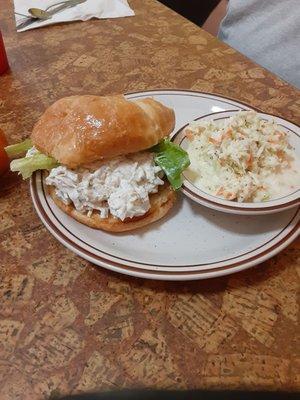 Chicken salad on croissant and cole slaw..