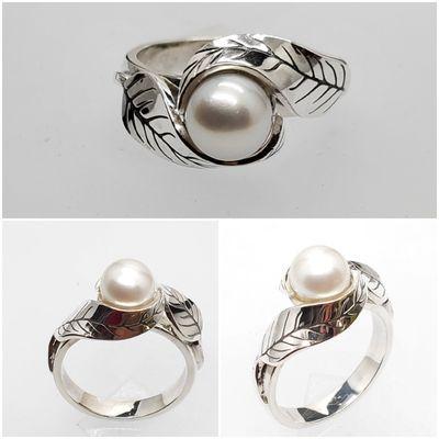 Customer comes in and says: I want a cultured pearl in the center with 2 leaves in it. Sure , why not, and here it is.