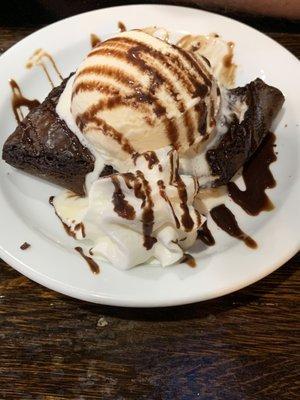 For dessert a big brownie with a big scoop of ice cream