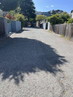 Our very beat up, rutted city long block alleyway before repair