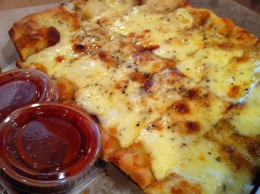 Cheese breadsticks with sauce.