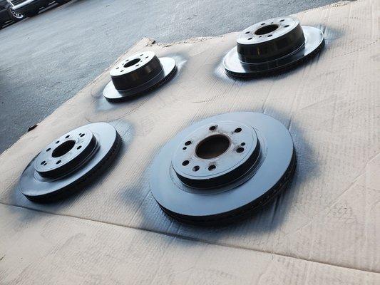 Rotors being painted black after resurfacing.