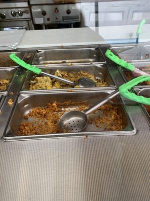 Dried out food in almost empty trays .