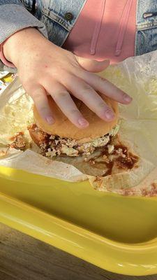 Large bbq pork sandwich with coleslaw in it as big as my hand