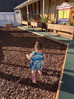 great outdoor space with a garden, sand box, reading nook, play structures, bikes / balls / toys, water play station, picnic area!