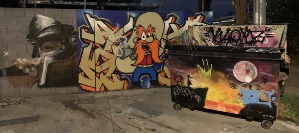 This is the dumpster & wall mural with sick art work covering it.