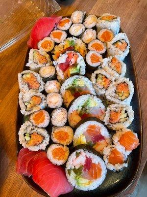 Take-out sushi, variety of rolls including Anything Roll (big one), Shrimp Roll, Spicy Tuna Box, Salmon Roll, Tuna Sushi