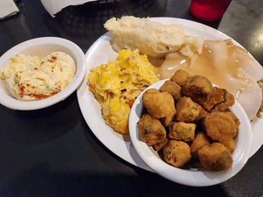 Turkey and Dressing with creamed potatoes, squash casserole, fried okra, and deviled eggs