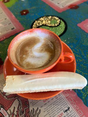 Lemon, almond biscotti with a cortado.