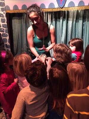 Puppeteer letting the children see and touch a marionette. Lovely