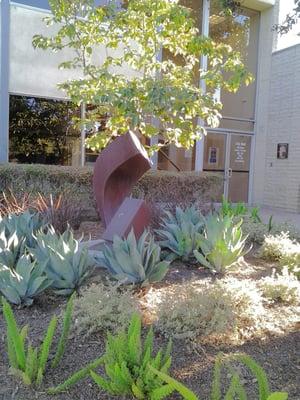 Small sculpture in the middle of drought tolerant landscaping