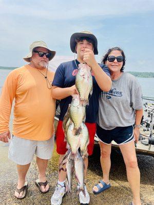 The Higginbotham family with a stringer of slabs from a recent guided crappie fishing trip on Grenada Lake in Grenada, Mississippi.