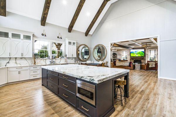 Paonazzo Marble kitchen countertops with large island and full backsplash.