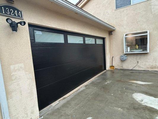 new modern flush black insulated garage door installed by us!