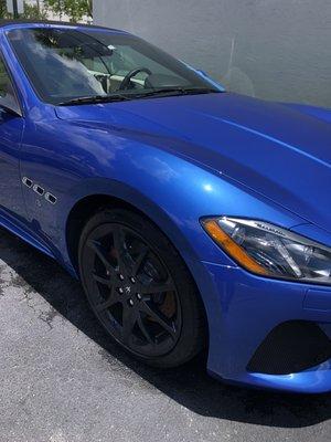 Deep blue Masserati getting a paste wax