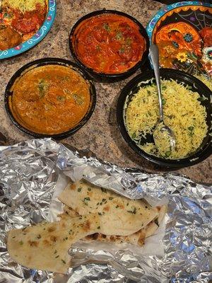 Butter chicken, chicken tikka masala, garlic naan and some flavorful rice!