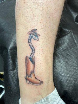 Snake in a boot tattoo by Milly