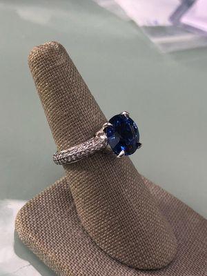 Custom sapphire center engagement ring with pave diamond band