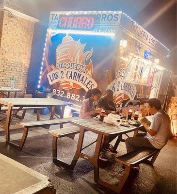 3 sets of benches outside of the food truck for seating